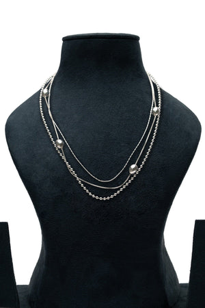 Orbit Layer Necklace – silver triple-layer necklace with mixed chain types and spaced round beads